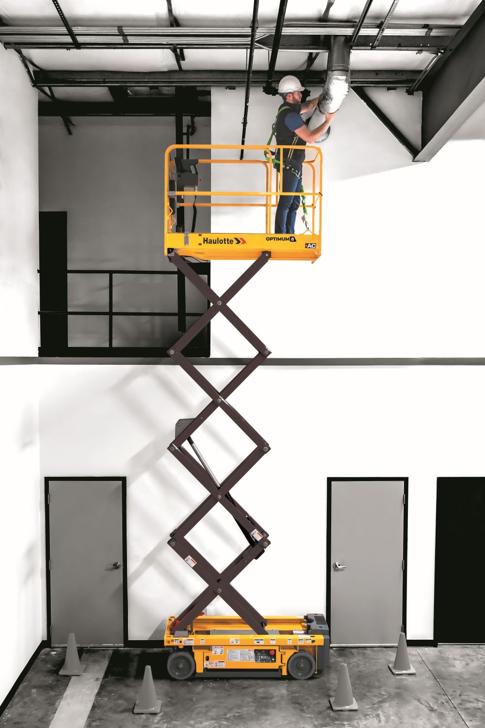 Scissor lift against building